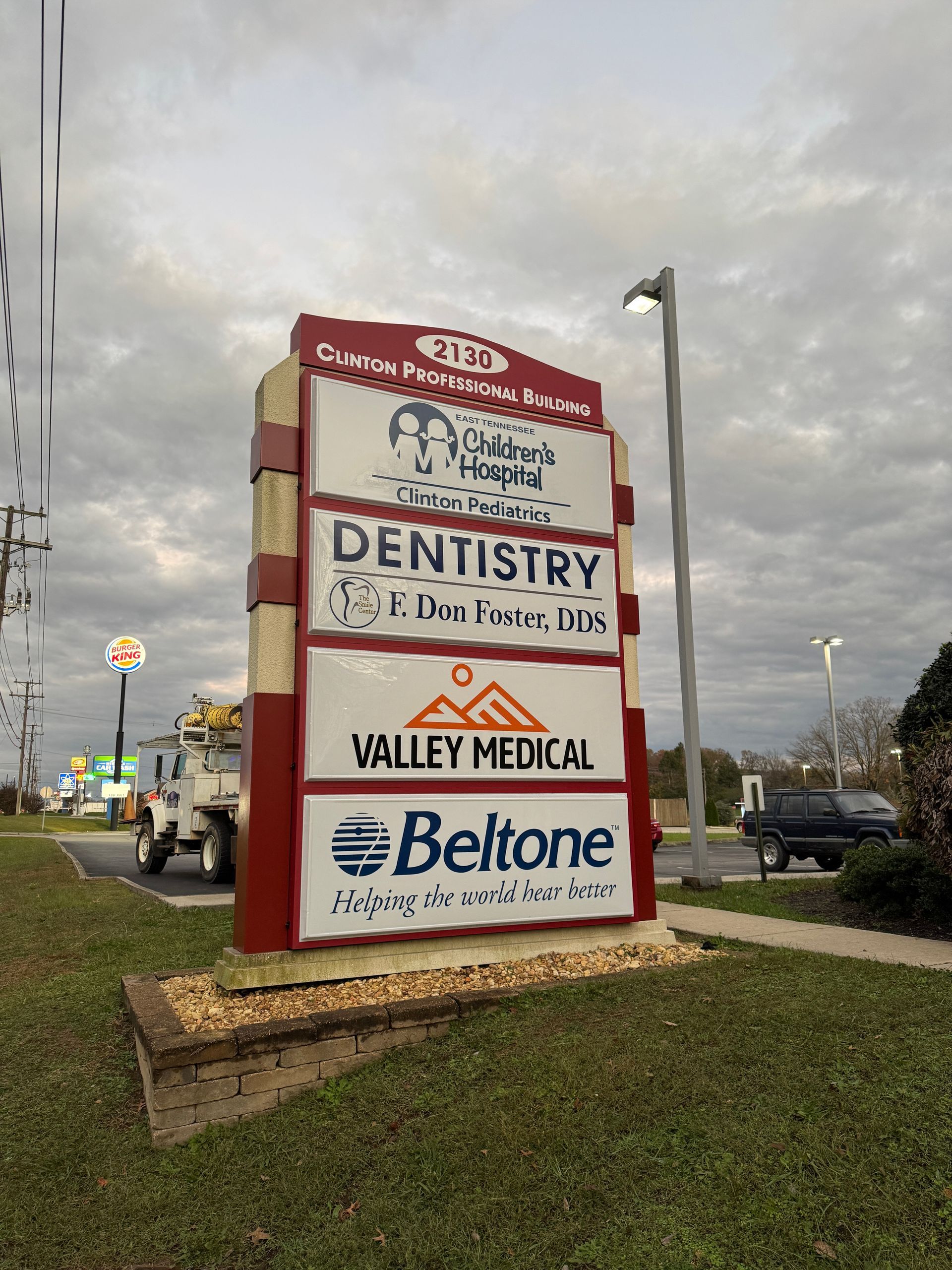 Sign for a medical complex with logos for Clinton Pediatric Healthcare, Dentistry, Valley Medical, and Beltone.