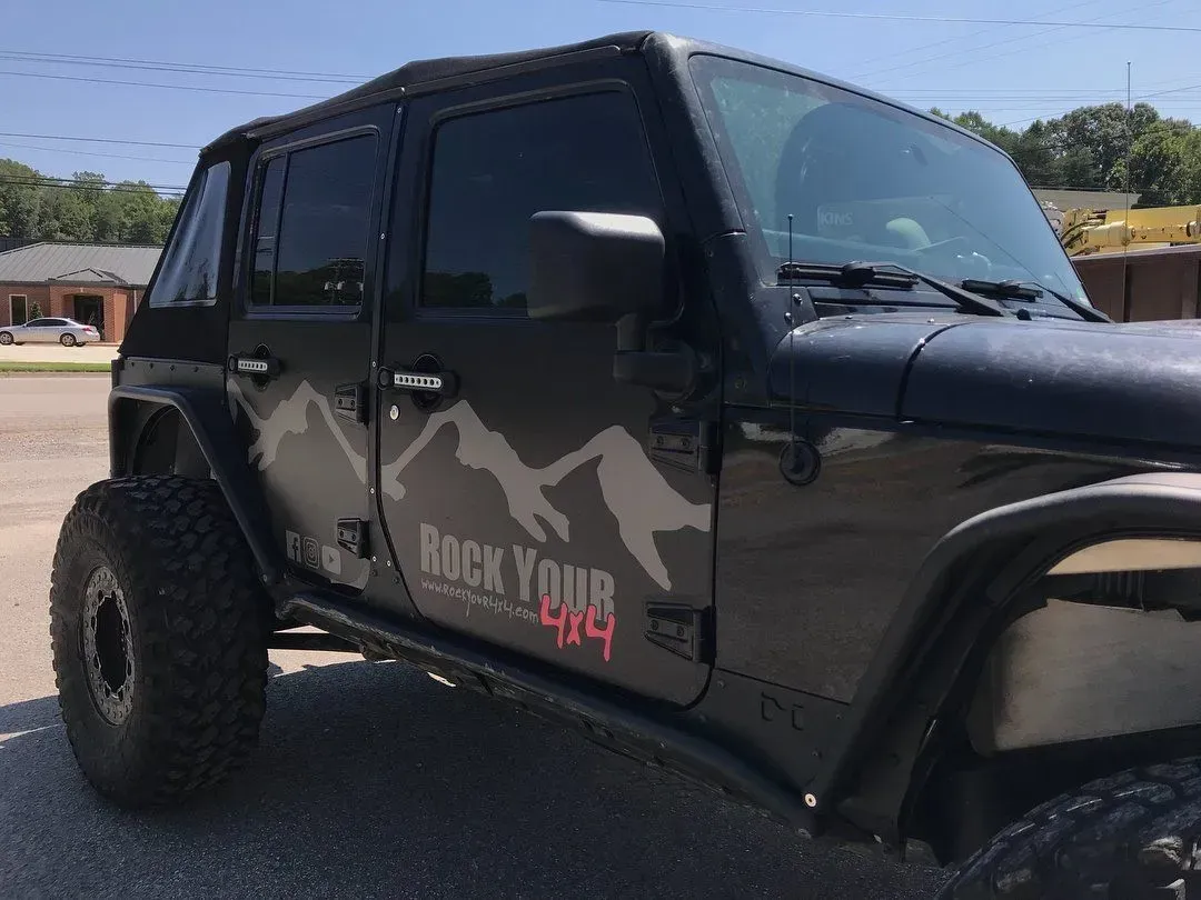 Black Jeep Wrangler with mountain graphic and 