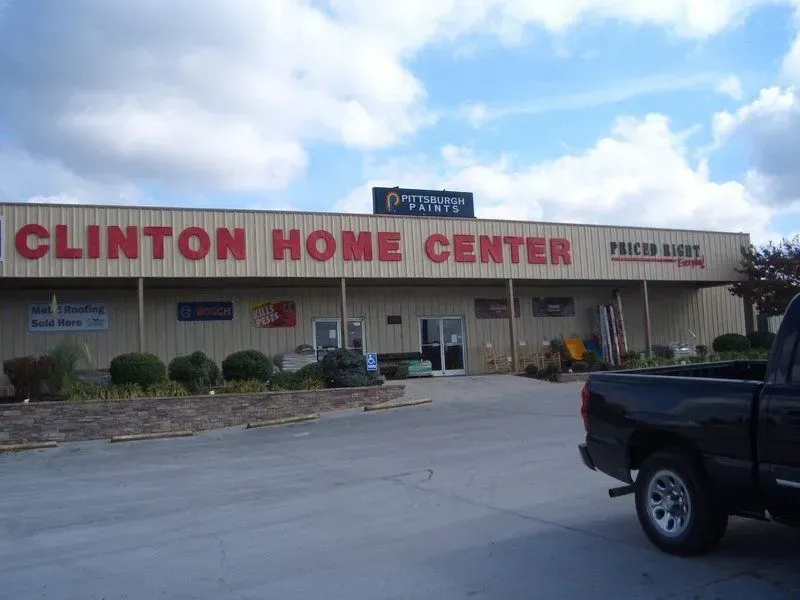 Clinton Home Center store with red lettering, tan building, and a pickup truck parked out front.