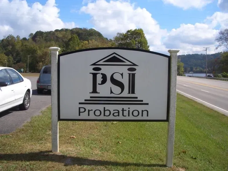 Sign for PSI Probation with logo, text, and street view.