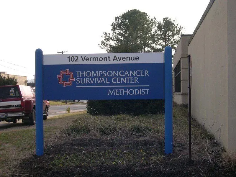 Sign for Thompson Cancer Survival Center at 102 Vermont Avenue, blue and white with Methodist logo.