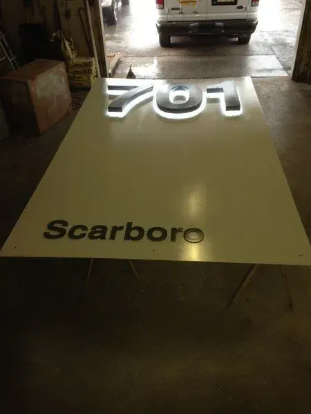 White sign with illuminated 