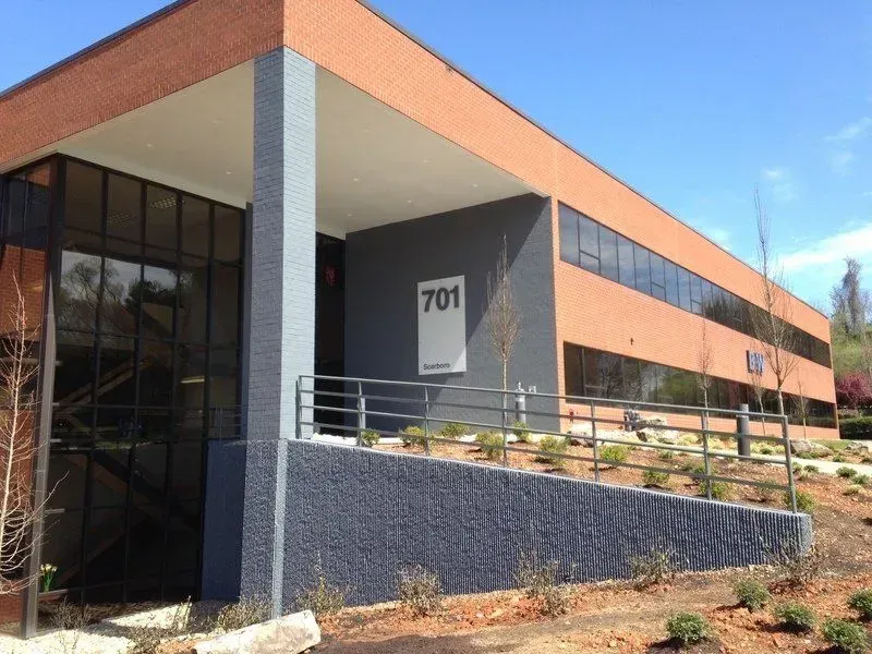 Exterior of a modern brick office building, entrance marked with 