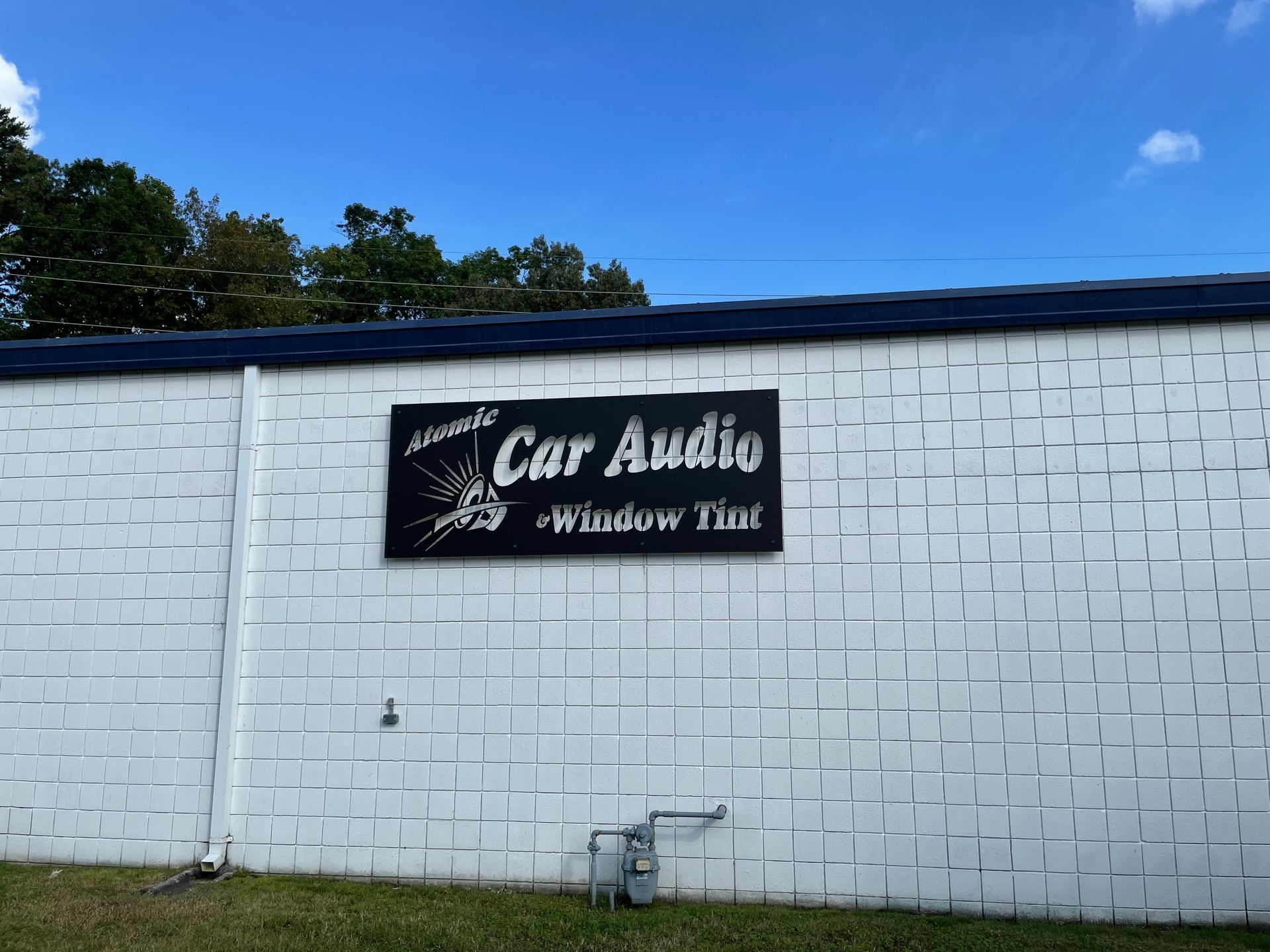 Sign on a white brick building: 