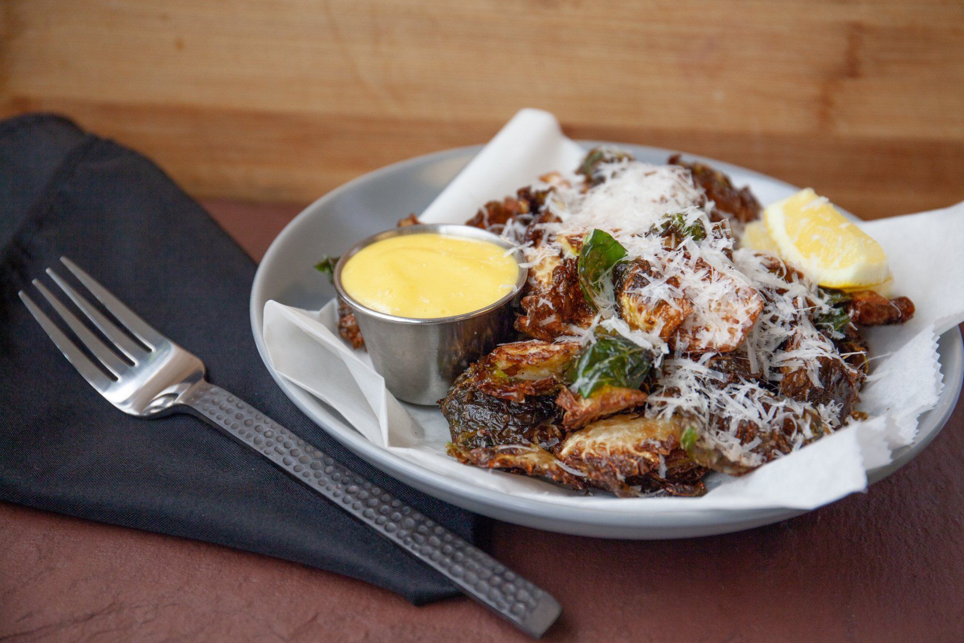 A plate of food with a fork next to it on a table.