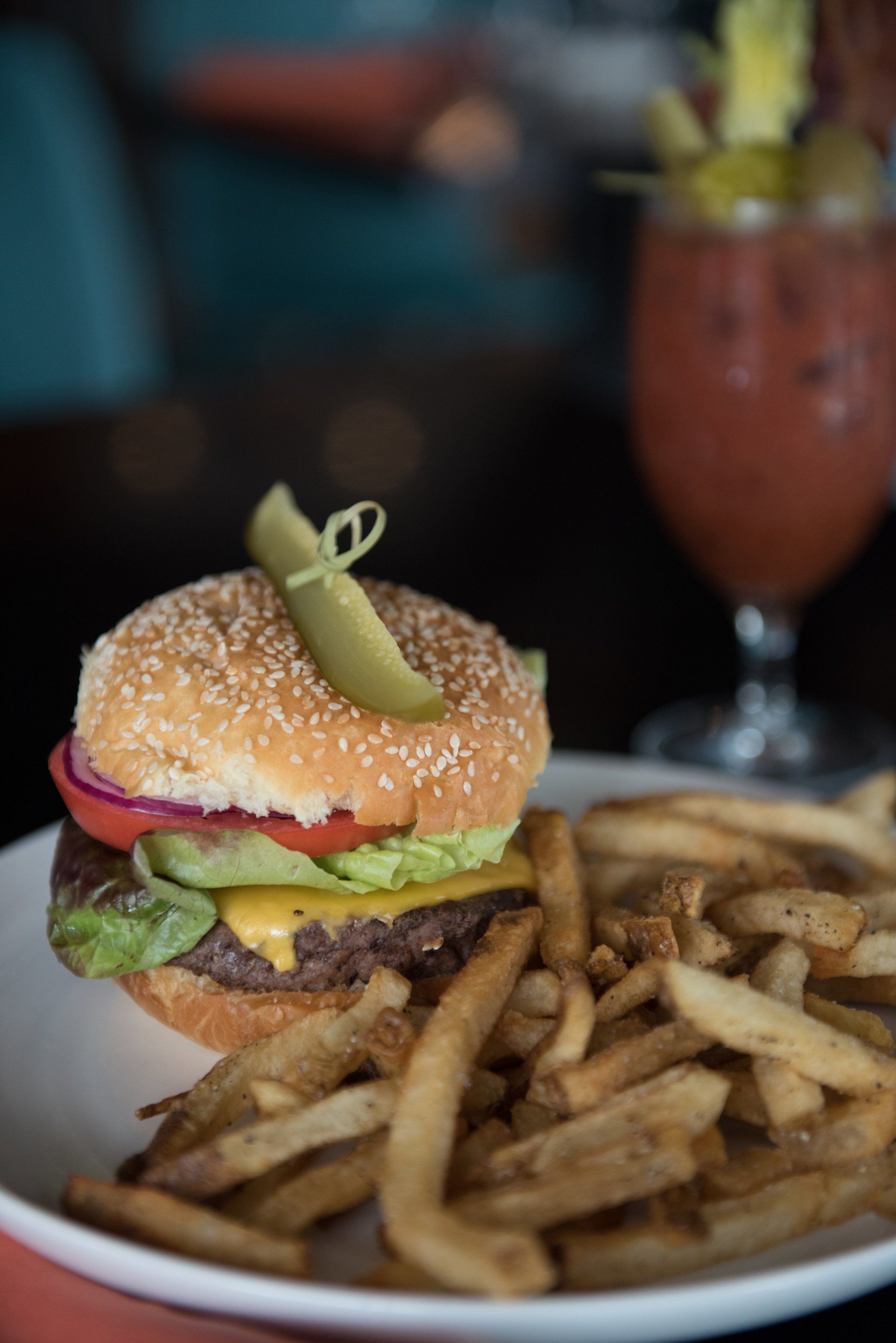 There is a hamburger and french fries on a plate.