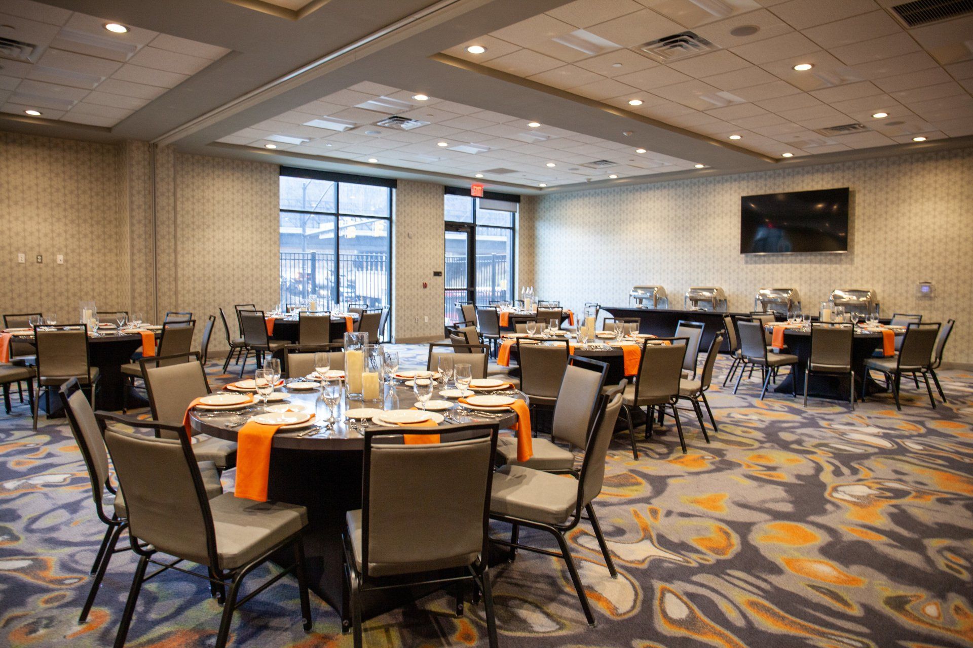 A large room with tables and chairs set up for a banquet.