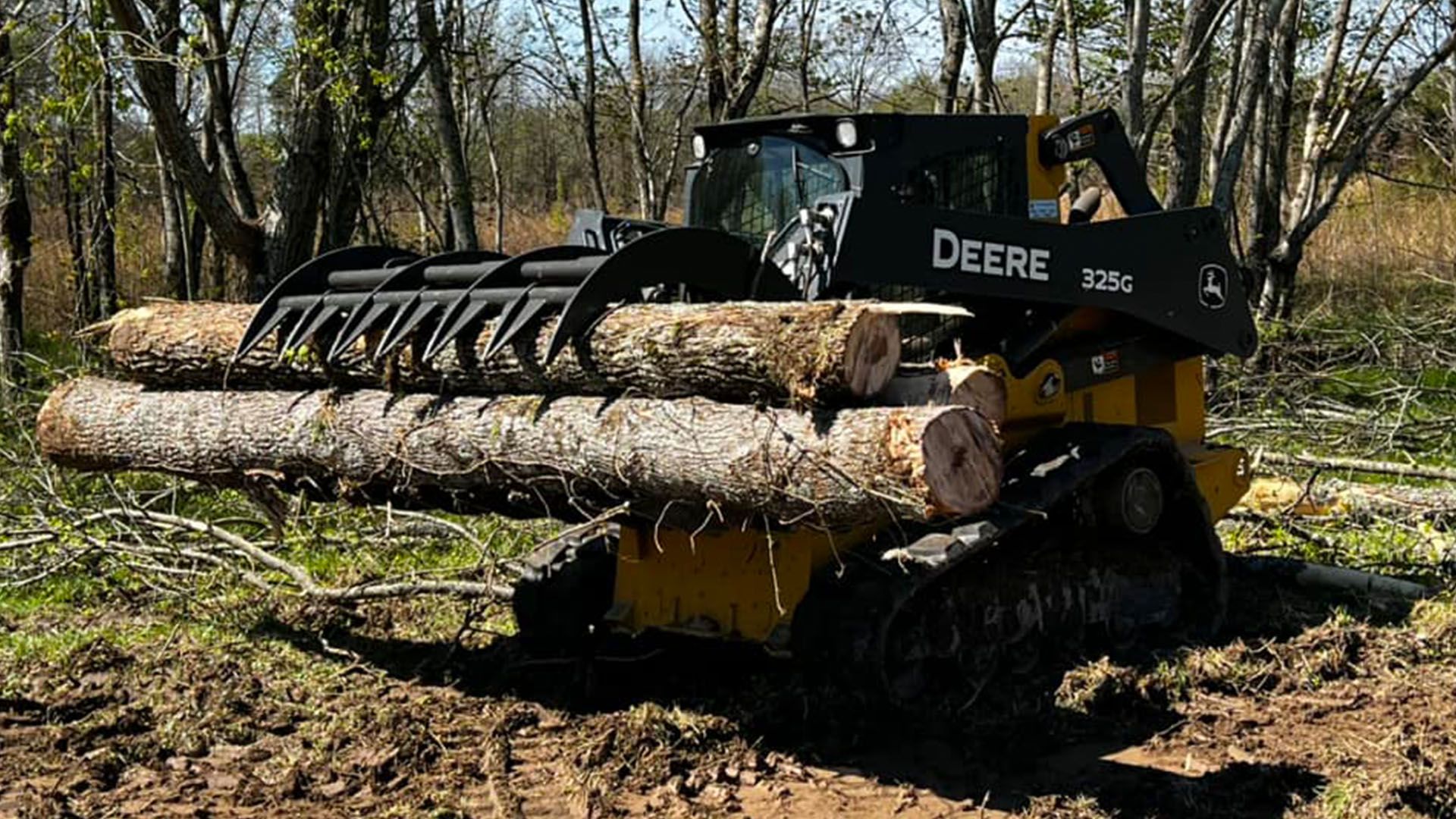 A yellow excavator is loading dirt into a dump truck.