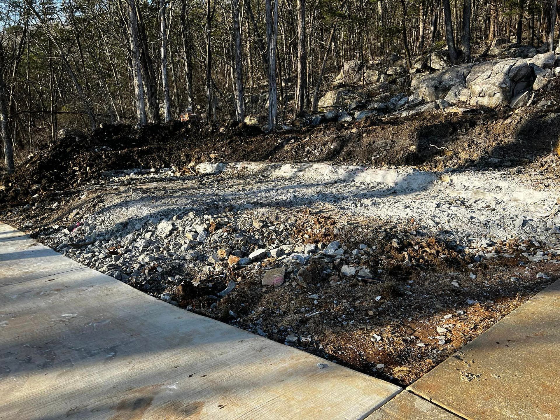 There is a lot of dirt and rocks on the side of the road.