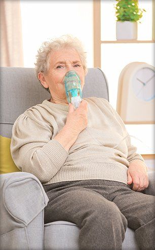 Senior using a nebulizer