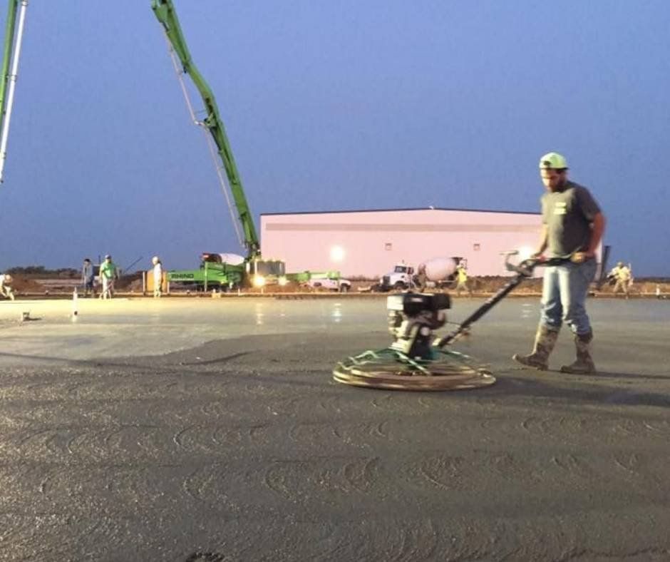 A man is working on a concrete surface with a machine