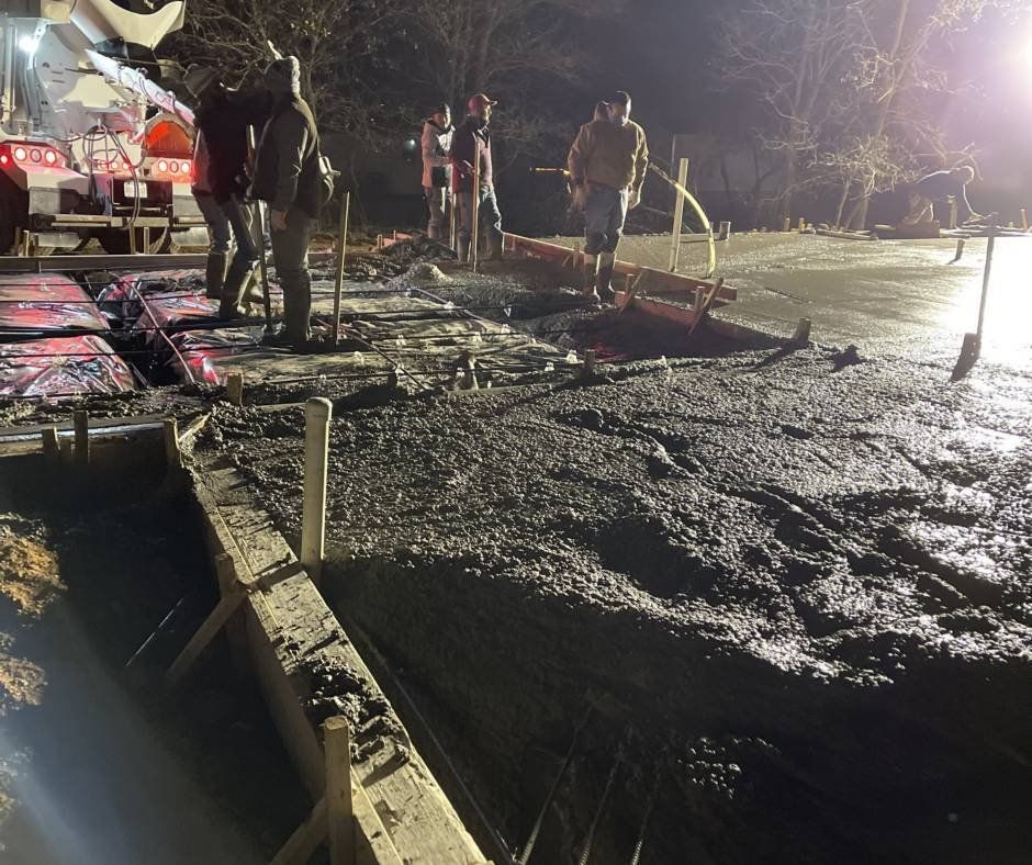 A group of men are working on a construction site at night