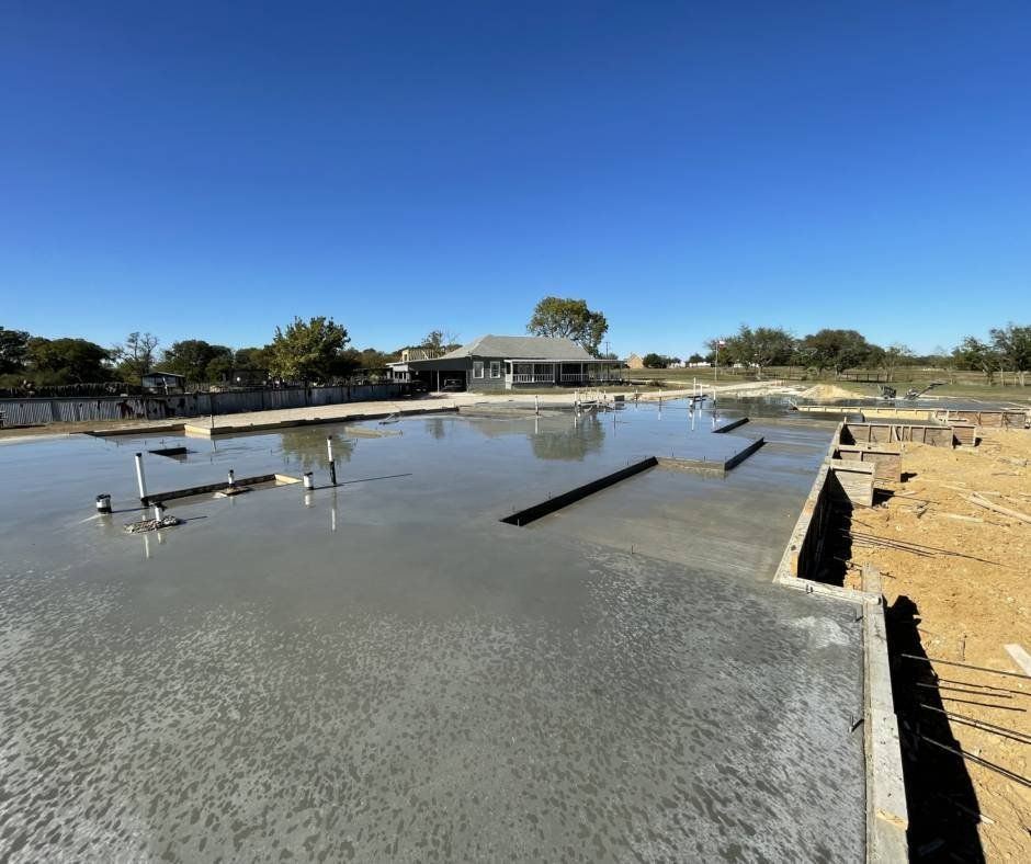 A large body of water with a house in the background.