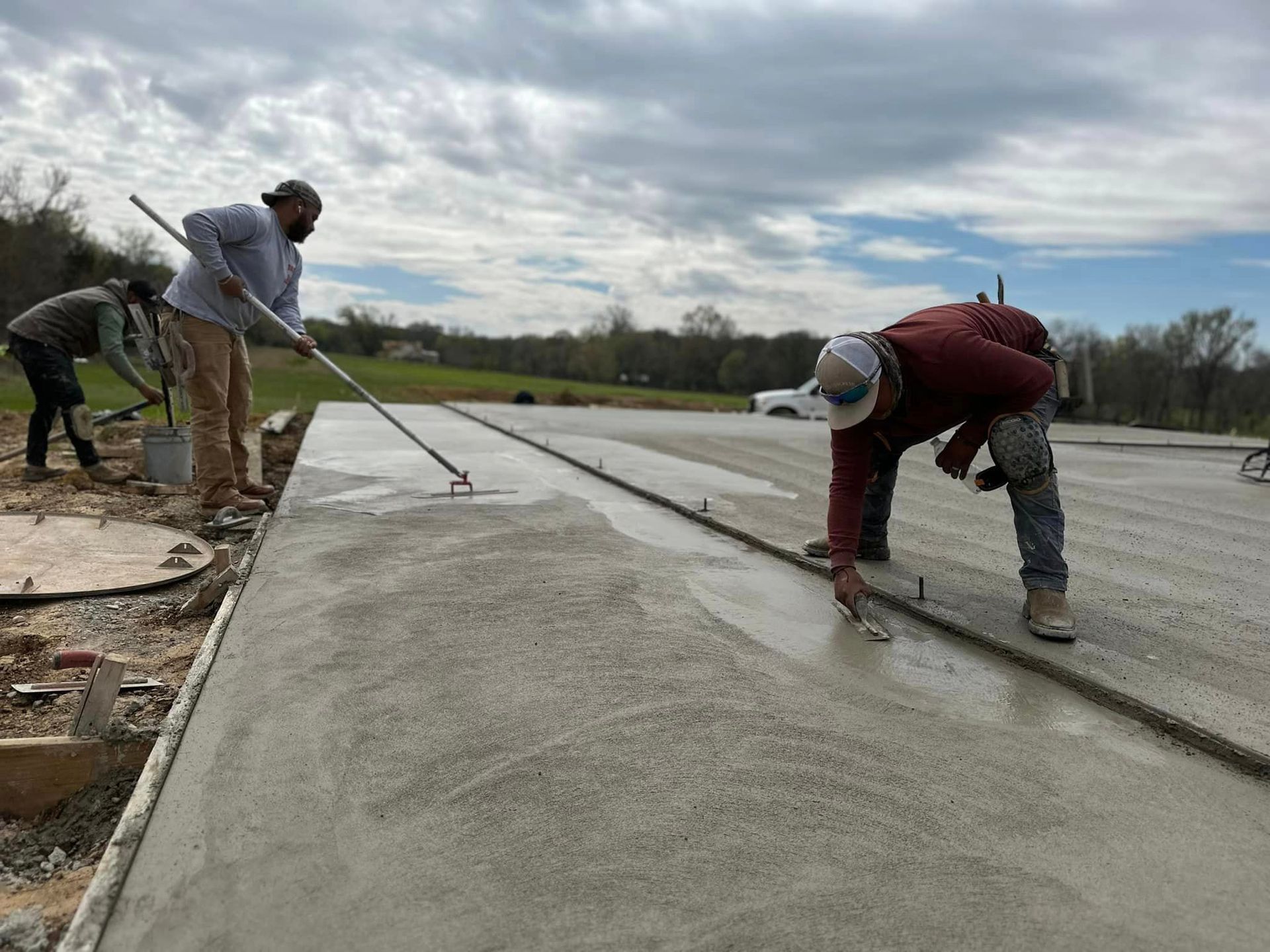 A group of construction workers are working on a concrete floor.