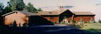 A large red brick house with a driveway leading to it