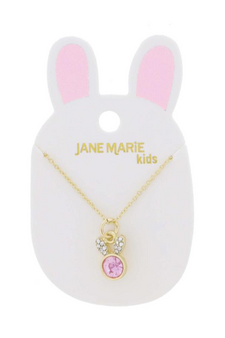 A necklace is on a card in the shape of a bunny.