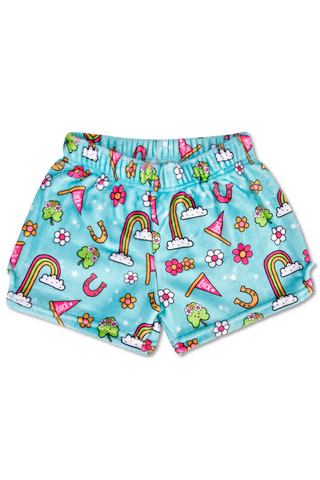 A pair of shorts with a pattern of rainbows , horseshoes , flowers and clouds on them.