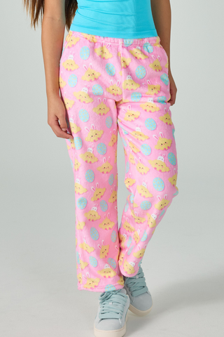 A woman wearing a blue shirt and pink pajama pants