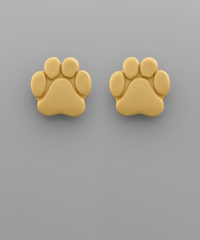 A pair of yellow paw print stud earrings on a gray surface.