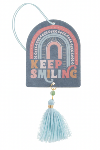 A car air freshener that says keep smiling