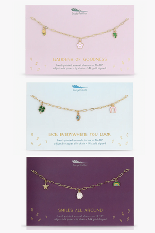 Three cards with necklaces on them one of which says smiles all around