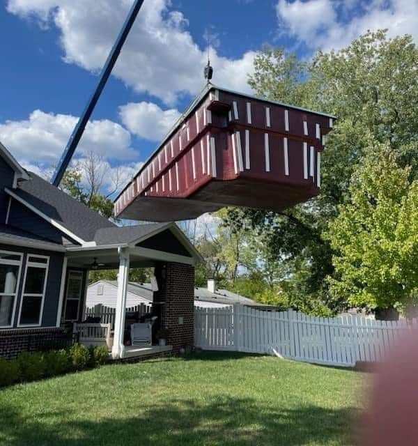 A swimming pool with a hot tub in the background