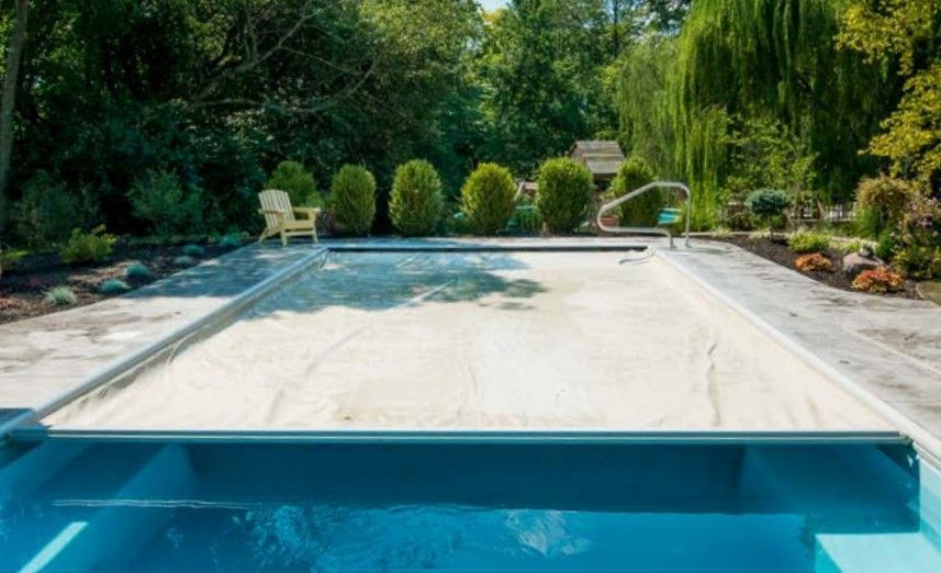 A large swimming pool with a cover on top of it.