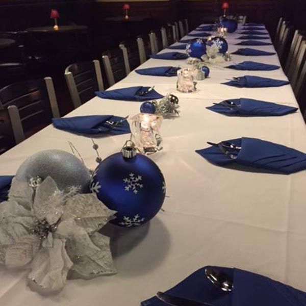 A long table with blue and silver christmas decorations