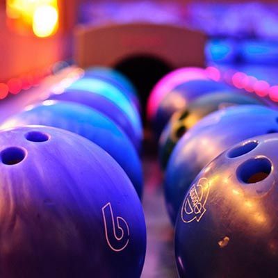 A row of bowling balls with the number 6 on them
