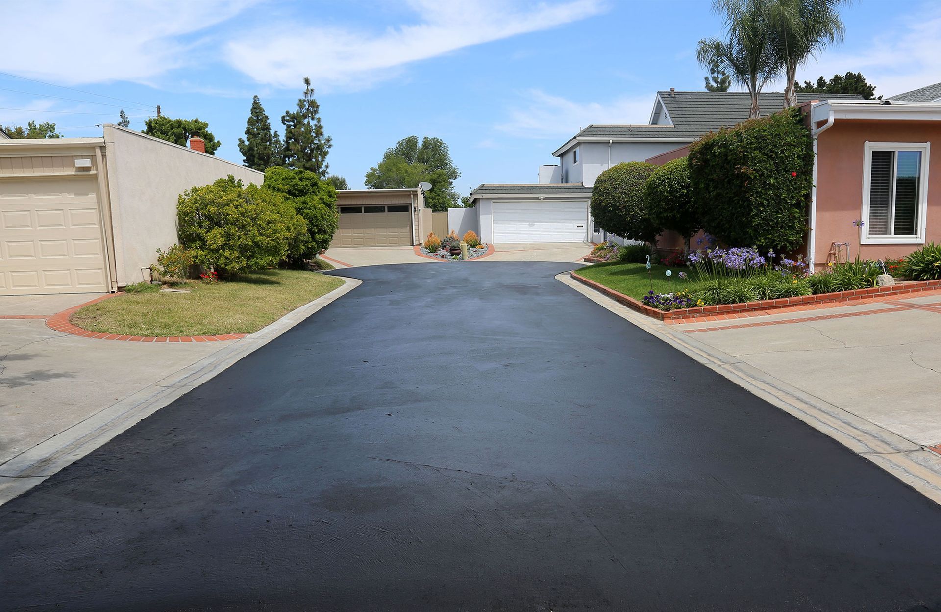 A newly paved driveway in a residential neighborhood