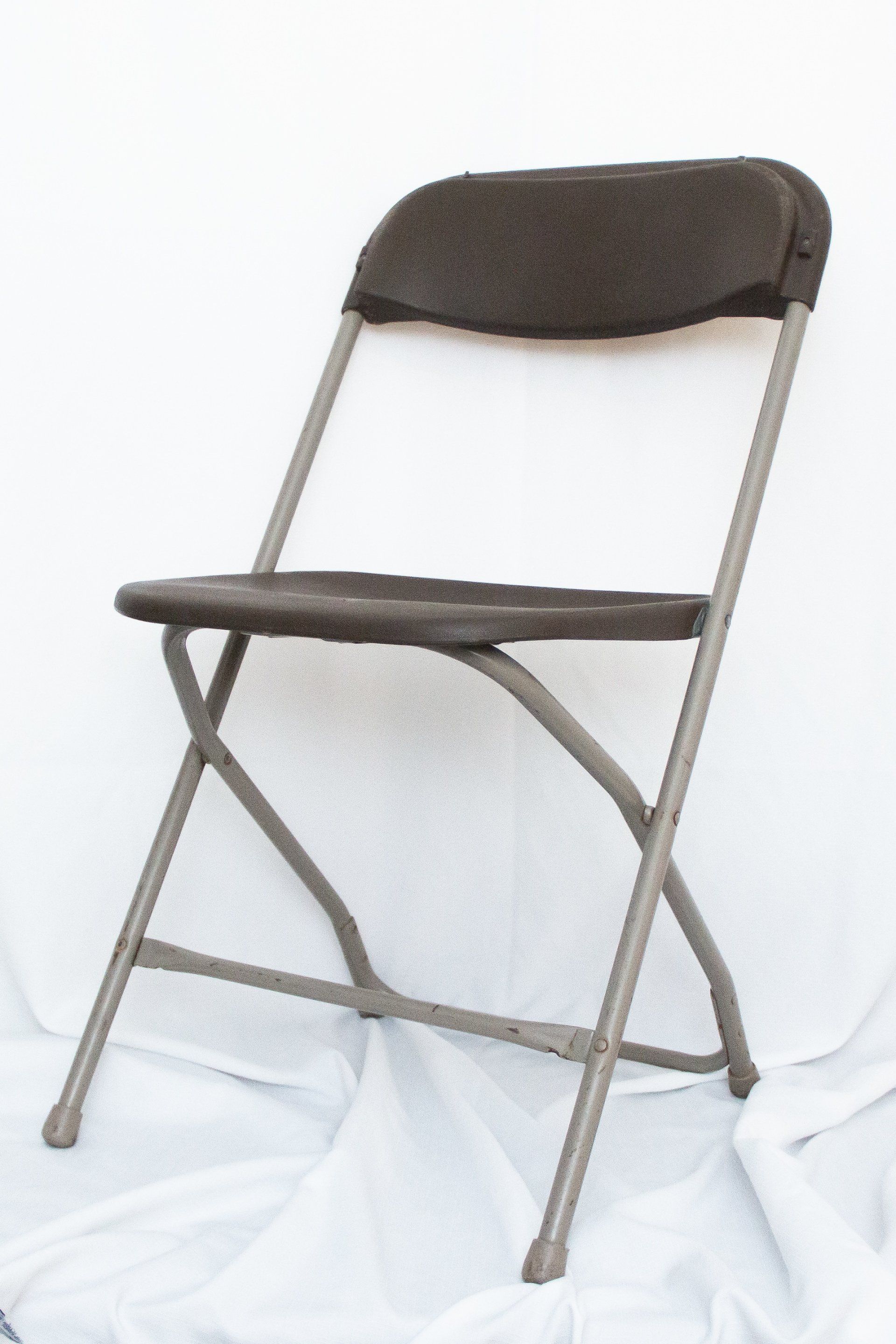 A folding chair is sitting on a white cloth