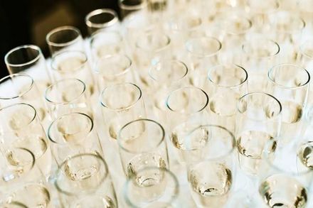 a bunch of champagne glasses sitting on top of each other on a table .