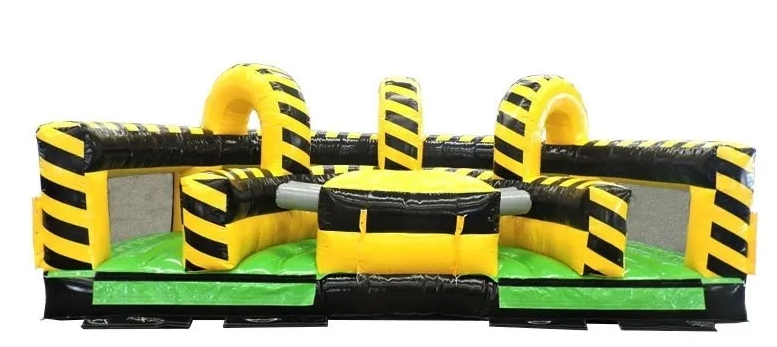 Inflatable obstacle course with yellow and black hazard stripes, arches, and a green base.