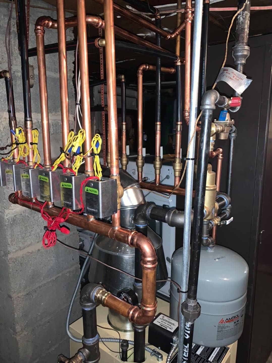 A bunch of copper pipes are connected to a machine