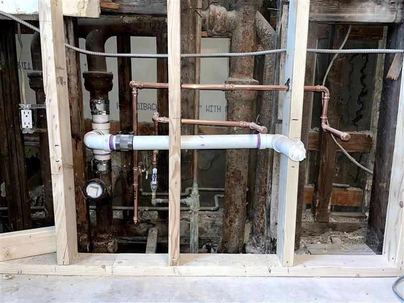 A wall with a lot of pipes coming out of it