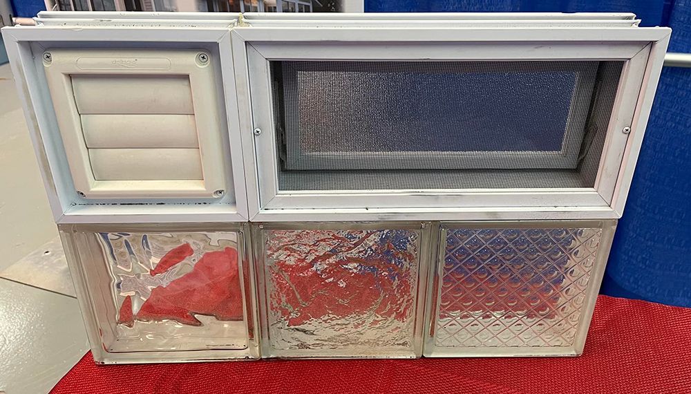 A stack of glass block windows sitting on top of a red table.