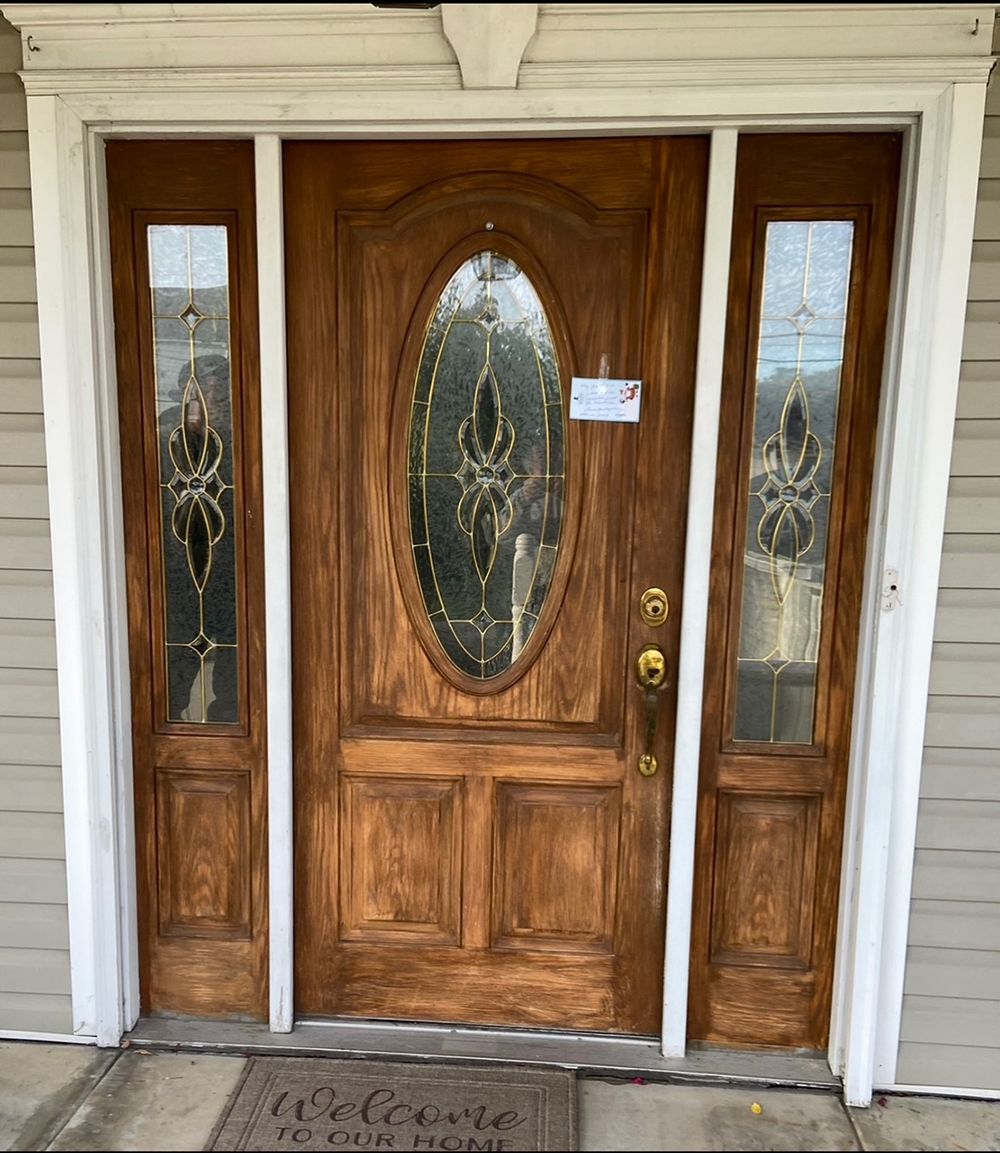 A wooden door with a welcome mat in front of it