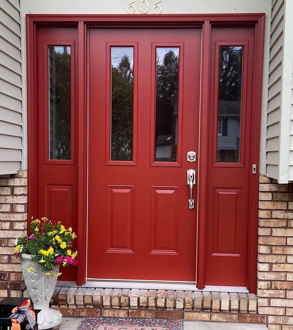 A red door with a brick wall behind it