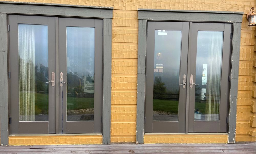 A row of sliding glass doors on the side of a building.