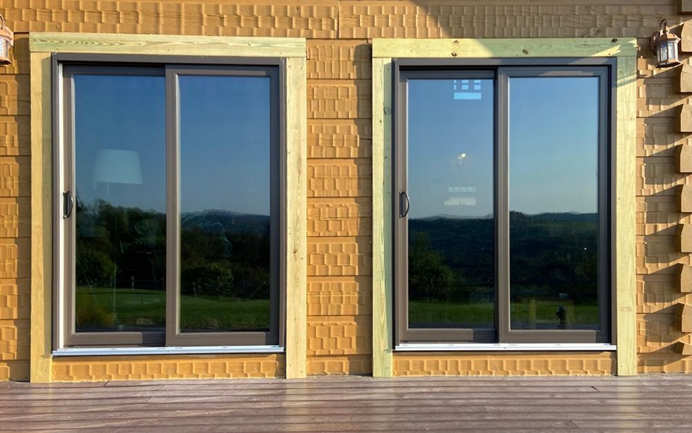 Two sliding glass doors are on the side of a building.