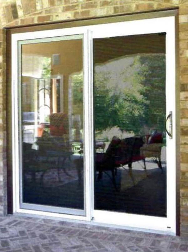 A white sliding glass door is open to a patio.