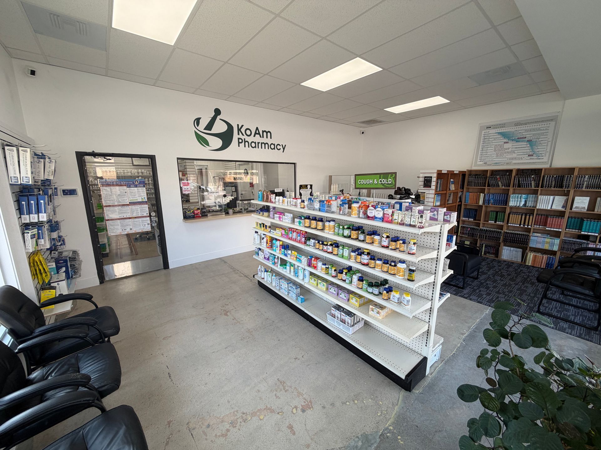 Inside a pet clinic waiting room with shelves of pet products, chairs, and a reception wall logo