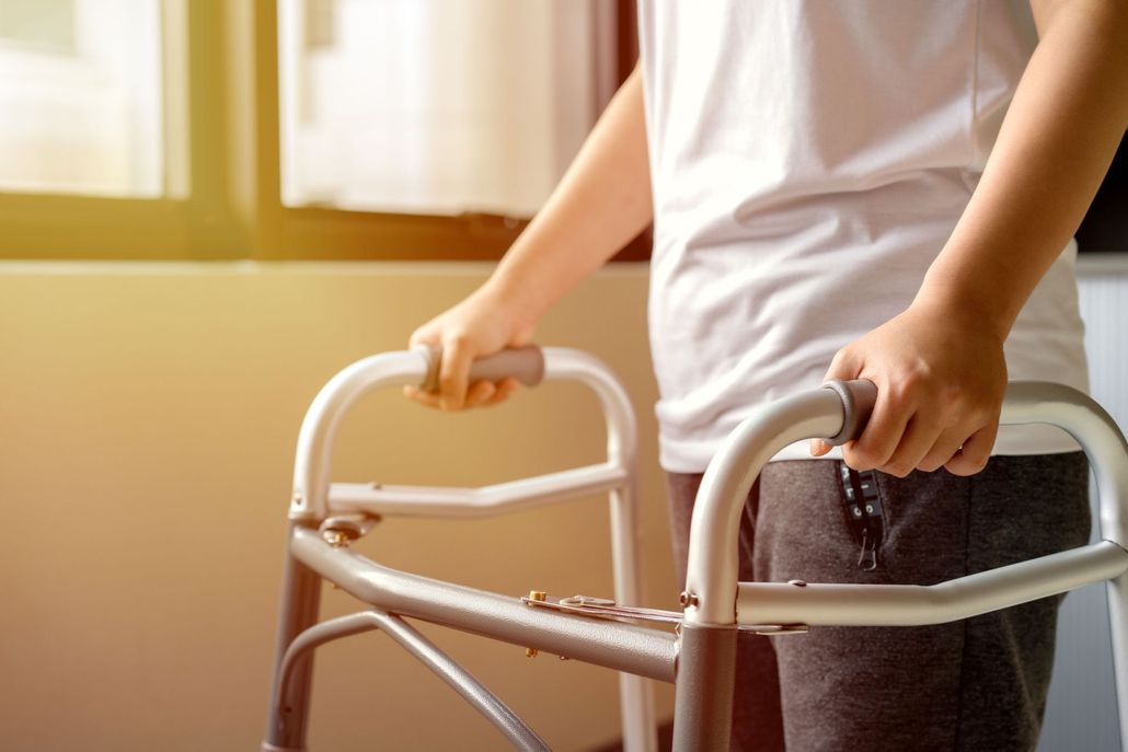 Woman seated in a wheelchair in a waiting area, facing the camera