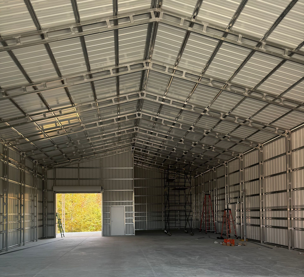 Dark-colored building exterior with a porch, two chairs, and a window.