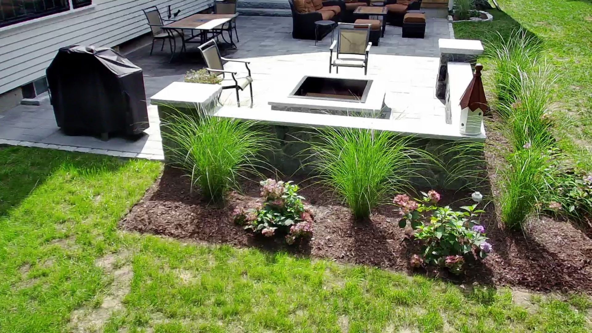 There is a fire pit in the middle of the backyard.