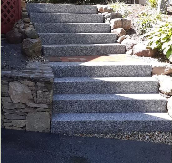 A set of stairs leading up to a stone wall