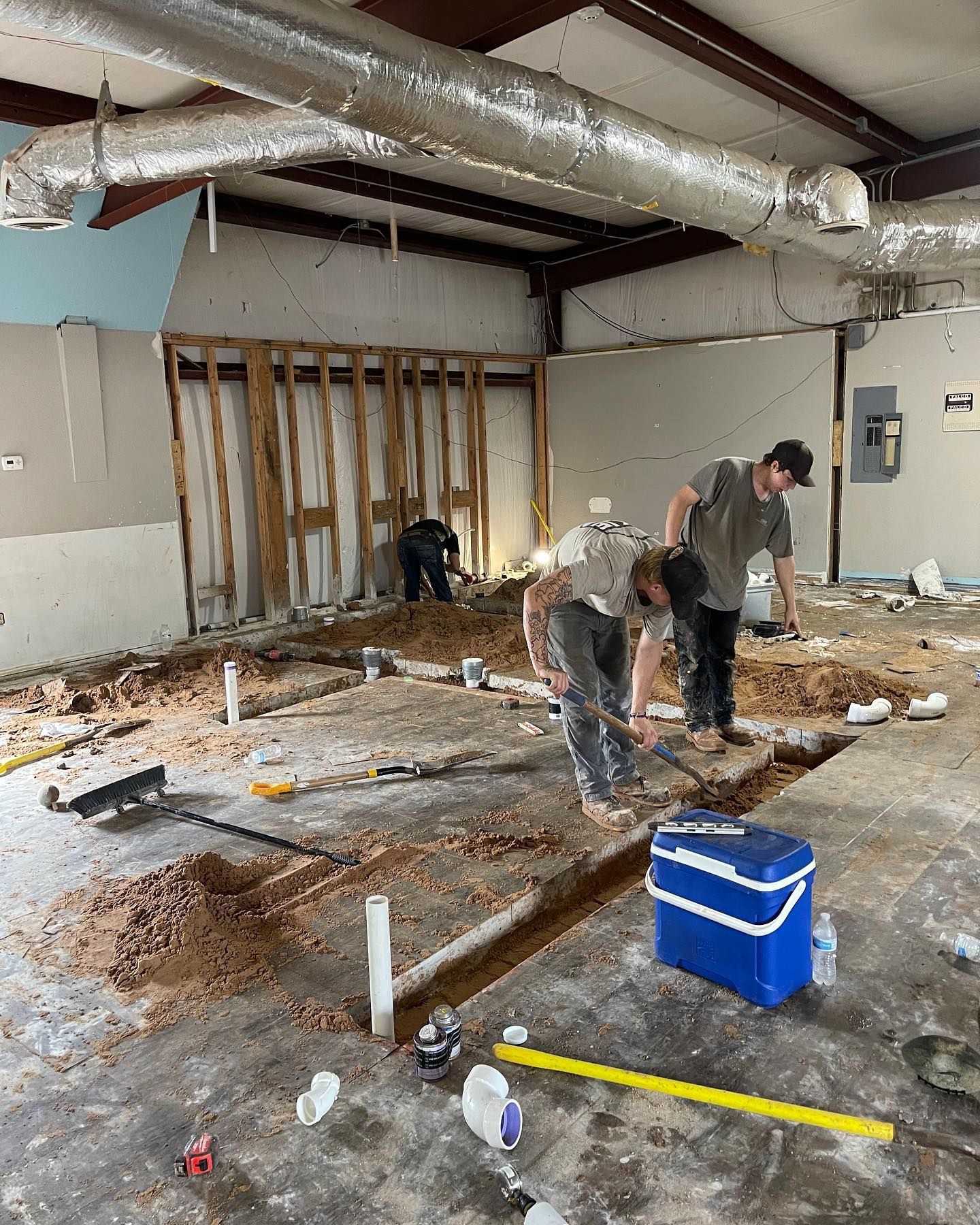 A group of men are working on the floor of a building.