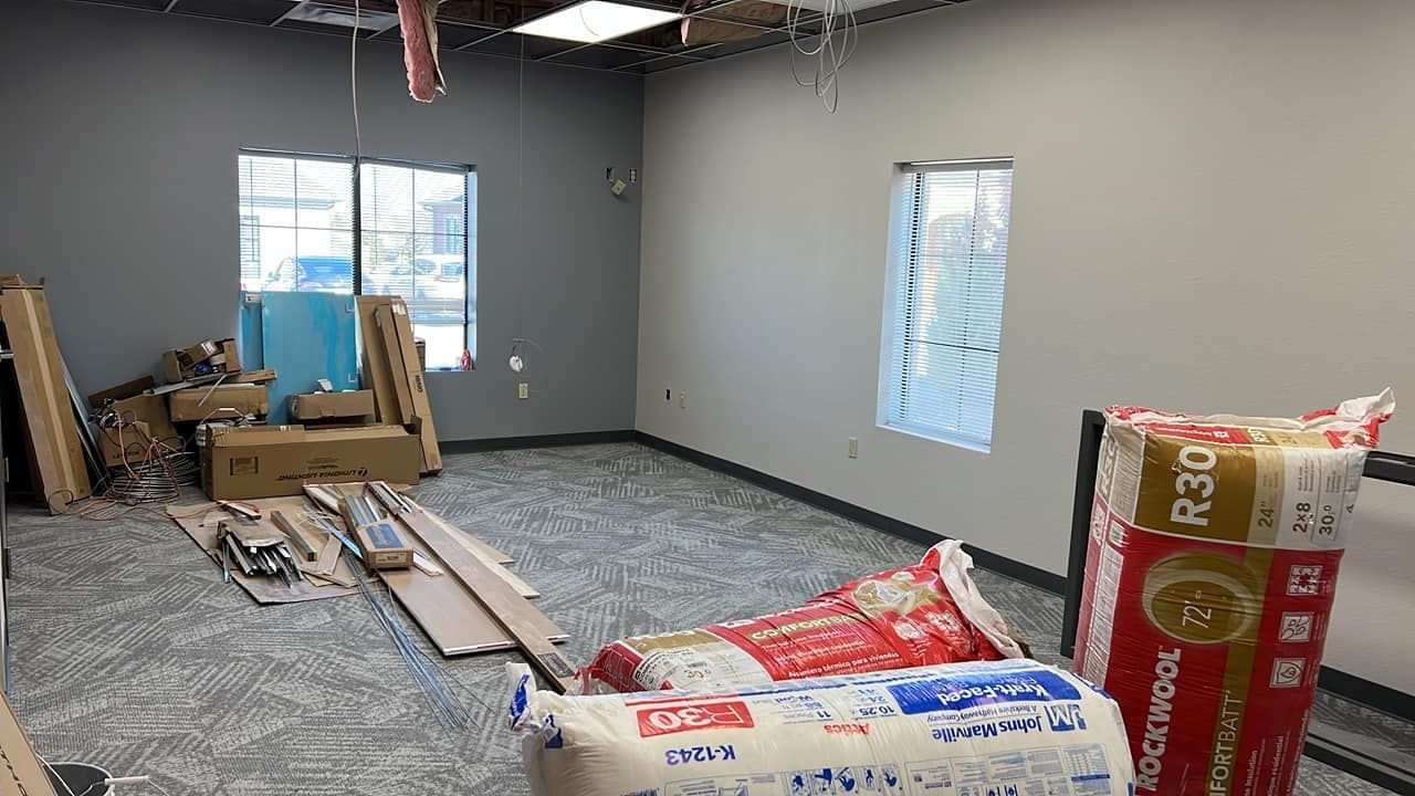 A room is being remodeled and there are bags of insulation in the room.