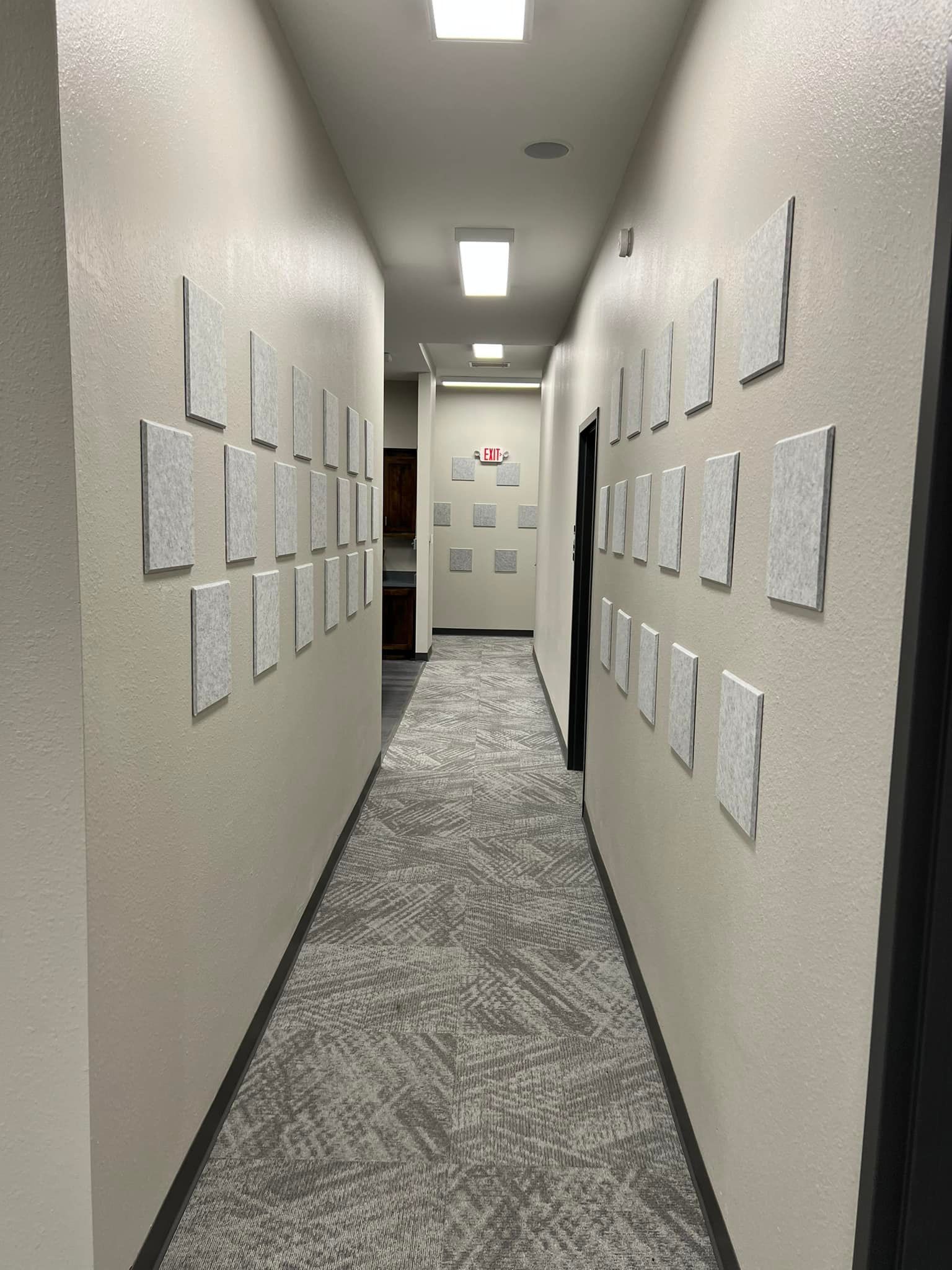 A long hallway with a lot of pictures on the wall.