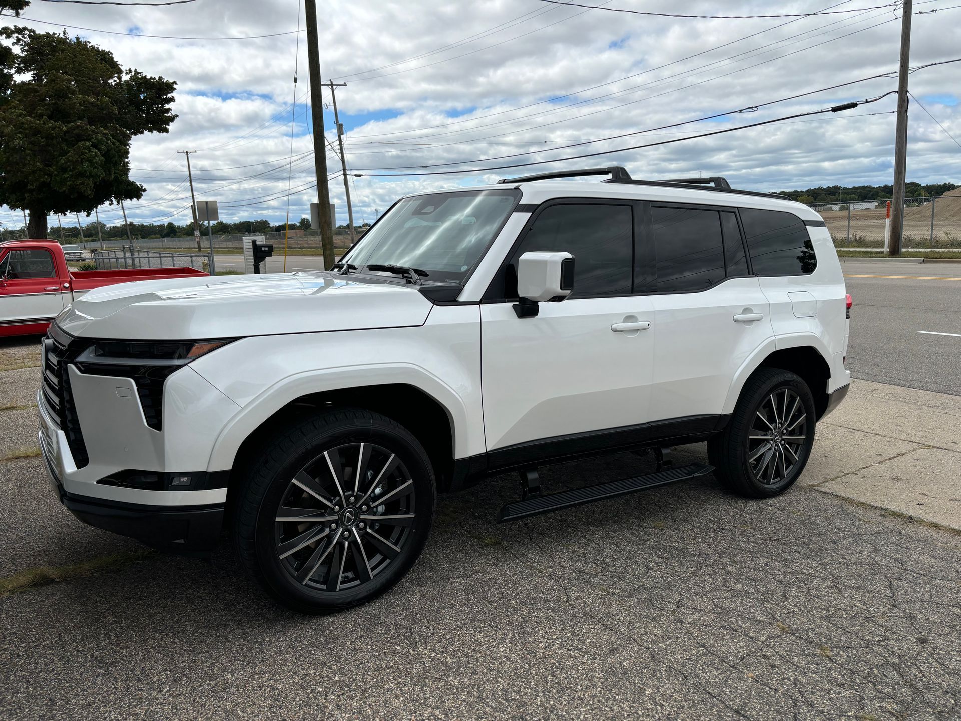 A white suv is parked on the side of the road.